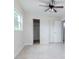 Bright bedroom features a ceiling fan, tile floors, and closet at 3411 W Paris St, Tampa, FL 33614