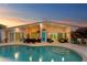 Inviting backyard features a pristine pool, cozy seating, and a covered tiki bar, perfect for outdoor relaxation at 3943 Fontainebleau Dr, Tampa, FL 33634