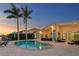 Waterfront backyard features a spacious pool, seating, and beautiful landscaping at 3943 Fontainebleau Dr, Tampa, FL 33634