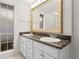 Bathroom featuring a double sink vanity with white cabinets and a stone countertop at 3943 Fontainebleau Dr, Tampa, FL 33634