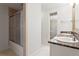 Bathroom with double sinks with granite countertop, decorative mirror and sliding glass shower door at 3943 Fontainebleau Dr, Tampa, FL 33634