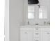 Bathroom features a double sink vanity with white cabinets, stone countertop, and large mirrors at 3943 Fontainebleau Dr, Tampa, FL 33634