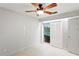 Bright bedroom featuring neutral colors, ceiling fan, and a sliding door to the pool area at 3943 Fontainebleau Dr, Tampa, FL 33634