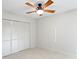 Bedroom with white walls and a ceiling fan with decorative lighting and a large closet for storage at 3943 Fontainebleau Dr, Tampa, FL 33634