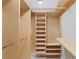 Large walk-in closet with custom wood shelving and multiple clothing racks for optimal organization and storage at 3943 Fontainebleau Dr, Tampa, FL 33634