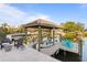 Covered waterfront dock with boat lift and seating at 3943 Fontainebleau Dr, Tampa, FL 33634