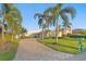 Inviting home with a brick driveway, a well-manicured lawn, mature trees, and a stylish front door at 3943 Fontainebleau Dr, Tampa, FL 33634