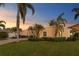 Beautiful single-story home with brick driveway, mature landscaping, and a colorful front door at 3943 Fontainebleau Dr, Tampa, FL 33634