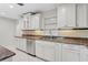 Well-lit kitchen showcases white cabinets, granite countertops, and stainless steel dishwasher at 3943 Fontainebleau Dr, Tampa, FL 33634