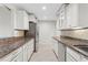 Elegant kitchen featuring white cabinetry, stainless steel appliances, and granite counters at 3943 Fontainebleau Dr, Tampa, FL 33634