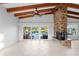 Inviting living area featuring a prominent brick fireplace and expansive sliding doors leading to outdoor pool area at 3943 Fontainebleau Dr, Tampa, FL 33634