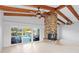Light-filled living area with a brick fireplace and sliding glass doors offering serene views of the backyard pool and waterfront at 3943 Fontainebleau Dr, Tampa, FL 33634