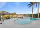 Inviting pool area with travertine tile, waterfront views, lounging chairs, and a covered dock at 3943 Fontainebleau Dr, Tampa, FL 33634