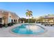 Inviting pool area with travertine tile, lush landscaping, covered bar, and waterfront views at 3943 Fontainebleau Dr, Tampa, FL 33634