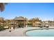 Waterfront pool area with travertine tile, lounging chairs, covered dock, and canal views at 3943 Fontainebleau Dr, Tampa, FL 33634