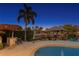 Outdoor pool area featuring waterfront views, shaded seating, a bar, and lush landscaping at 3943 Fontainebleau Dr, Tampa, FL 33634