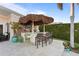 Outdoor Tiki bar area complete with seating, grill, and plenty of space to entertain at 3943 Fontainebleau Dr, Tampa, FL 33634