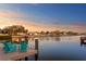 Waterfront home with a private dock furnished with Adirondack chairs, offering scenic views of the tranquil waters at 3943 Fontainebleau Dr, Tampa, FL 33634