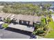 Aerial view of condo building with mature landscaping and covered parking at 4008 Passport Ln # 104, New Port Richey, FL 34653