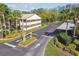 Woodtrail Condominiums entrance with well-maintained landscaping, and condo building at 4008 Passport Ln # 104, New Port Richey, FL 34653