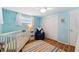 Bright Bedroom with light blue walls, white trim and colorful striped rug at 5046 Rosewood Dr, New Port Richey, FL 34653