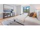 Spacious bedroom with modern furniture, a gray accent rug, and a decorative cabinet with mirror insets at 532 W Plaza Pl # 2, Tampa, FL 33602