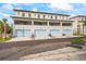Modern three-story townhome featuring multiple garages, balconies, and a sleek architectural design at 532 W Plaza Pl # 2, Tampa, FL 33602