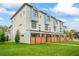 Modern townhome exterior featuring a manicured lawn and wood privacy fences at 532 W Plaza Pl # 2, Tampa, FL 33602