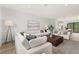 Open-concept living room with a large sectional, accent chairs, and a view into the kitchen at 532 W Plaza Pl # 2, Tampa, FL 33602
