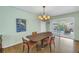 Dining room with modern light fixture and sliding doors to the patio area at 6250 11Th S Ave, Gulfport, FL 33707