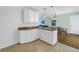 Kitchen island with granite countertop and white cabinets for ample storage and functionality at 6250 11Th S Ave, Gulfport, FL 33707