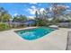 Backyard pool is surrounded by a concrete patio, a privacy fence and lush landscaping at 6250 11Th S Ave, Gulfport, FL 33707