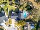 Aerial view of a home with a screened-in pool, landscaped backyard, and well-maintained surroundings at 7115 Edenwood Pl, Tampa, FL 33615