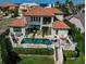 Beautiful backyard with swimming pool, spa, patio area, and meticulously manicured landscaping at 912 Symphony Beach Ln, Apollo Beach, FL 33572