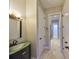 This bathroom features a vanity sink, neutral walls, and travertine floors at 912 Symphony Beach Ln, Apollo Beach, FL 33572
