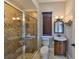 Updated bathroom with glass shower, decorative lighting, single vanity and tiled floors at 912 Symphony Beach Ln, Apollo Beach, FL 33572
