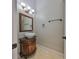 Quaint bathroom featuring pedestal sink, decorative lighting and a framed mirror at 912 Symphony Beach Ln, Apollo Beach, FL 33572