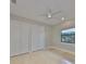 This bedroom features travertine floors, neutral walls, and a ceiling fan at 912 Symphony Beach Ln, Apollo Beach, FL 33572
