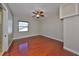 This bedroom features hardwood floors, neutral walls, and a ceiling fan at 912 Symphony Beach Ln, Apollo Beach, FL 33572