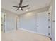 This bedroom features tile floors, neutral walls, and a ceiling fan at 912 Symphony Beach Ln, Apollo Beach, FL 33572