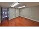 Bonus room with hardwood floors and two doors leading to other parts of the house at 912 Symphony Beach Ln, Apollo Beach, FL 33572