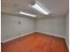 Bonus room showing hardwood floors, neutral colored walls and overhead lighting at 912 Symphony Beach Ln, Apollo Beach, FL 33572