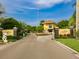 Welcoming entrance to Symphony Isles with a guard house, an American flag, and manicured landscaping at 912 Symphony Beach Ln, Apollo Beach, FL 33572