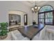 Dining room with large window, stone floors and a view to the living and office spaces at 912 Symphony Beach Ln, Apollo Beach, FL 33572