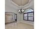 Dining room featuring stone floors, chandelier, and arched window with wooden shutters at 912 Symphony Beach Ln, Apollo Beach, FL 33572