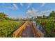 A scenic wooden walkway leading to a dock, overlooking a waterfront community at 912 Symphony Beach Ln, Apollo Beach, FL 33572