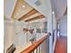 Foyer view from the loft, showcasing the staircase, decorative windows, and soaring ceilings at 912 Symphony Beach Ln, Apollo Beach, FL 33572