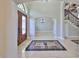 Grand foyer with a decorative floor design, chandelier and staircase with iron railings at 912 Symphony Beach Ln, Apollo Beach, FL 33572