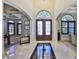Elegant foyer with high ceilings, arched windows, decorative doors and marble floors at 912 Symphony Beach Ln, Apollo Beach, FL 33572