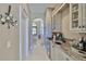 Hallway Wet Bar with custom cabinets, sink, and undercounter refrigerator at 912 Symphony Beach Ln, Apollo Beach, FL 33572